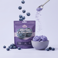 Protein ice cream mix package with blueberries and a scoop of ice cream on a light purple background